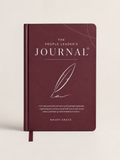The People Leader's Journal by Navah Grace, featuring a deep burgundy cover with elegant white typography and a feather illustration, shown on a light beige background.