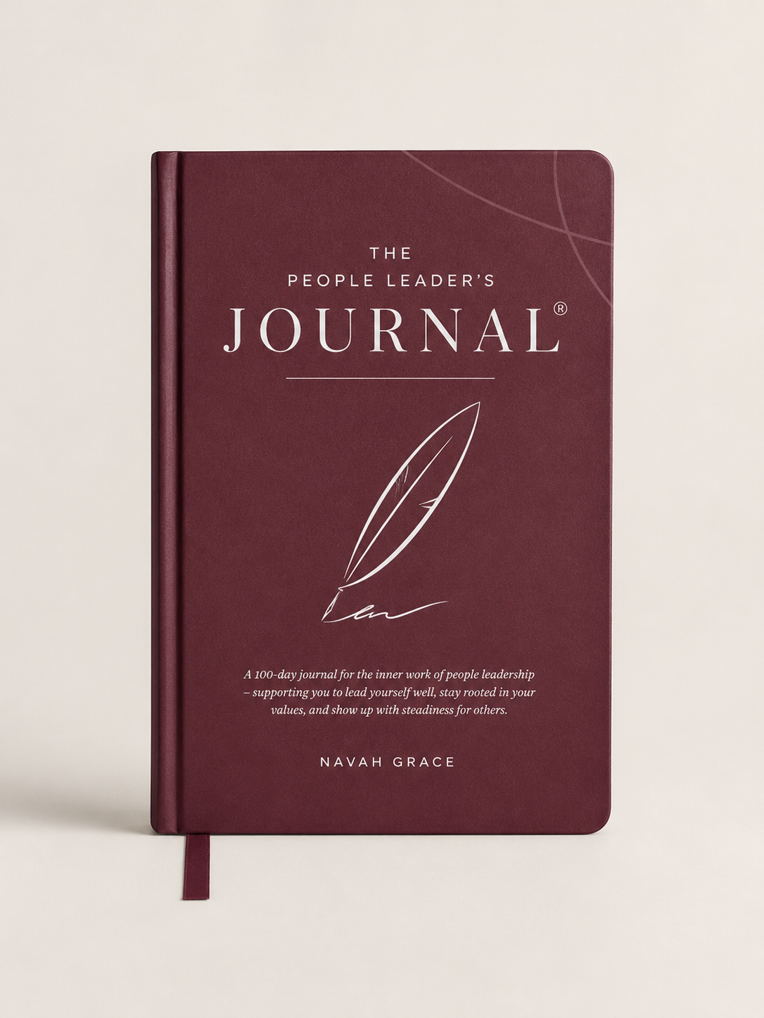 The People Leader's Journal by Navah Grace, featuring a deep burgundy cover with elegant white typography and a feather illustration, shown on a light beige background.